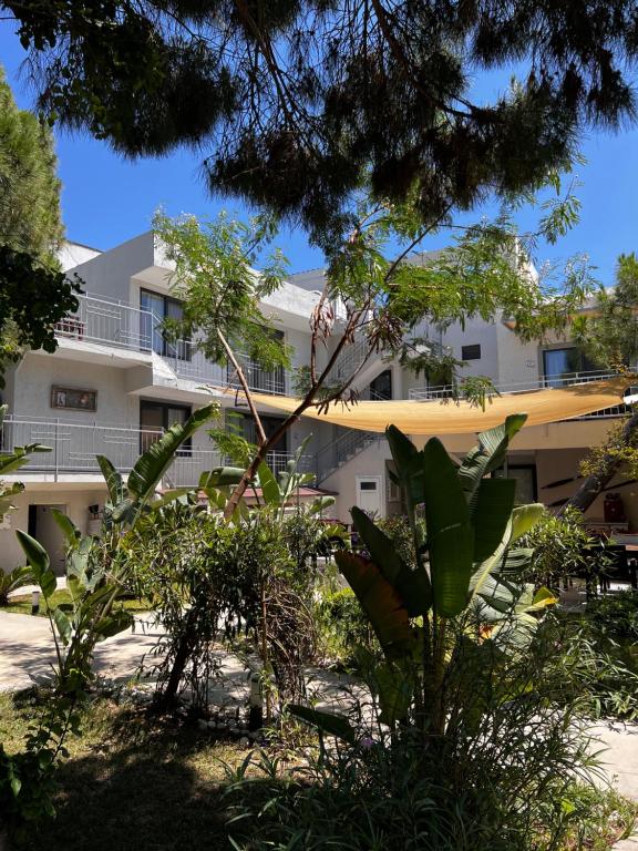 an apartment building with trees in front of it at ByAKKAN HOTEL in Bodrum City