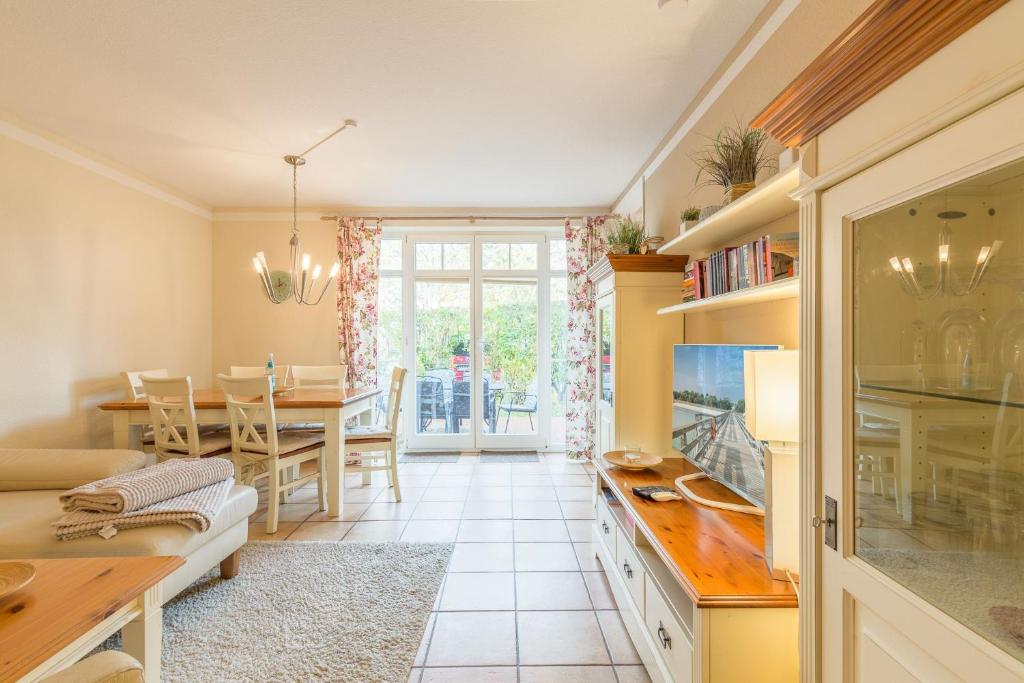 a kitchen and dining room with a table and chairs at Ferienhaus Josephin in Boltenhagen