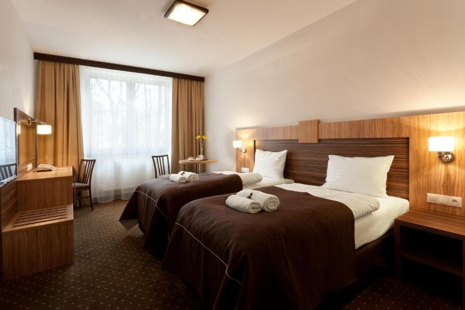 Postel nebo postele na pokoji v ubytování Hotel Milenium