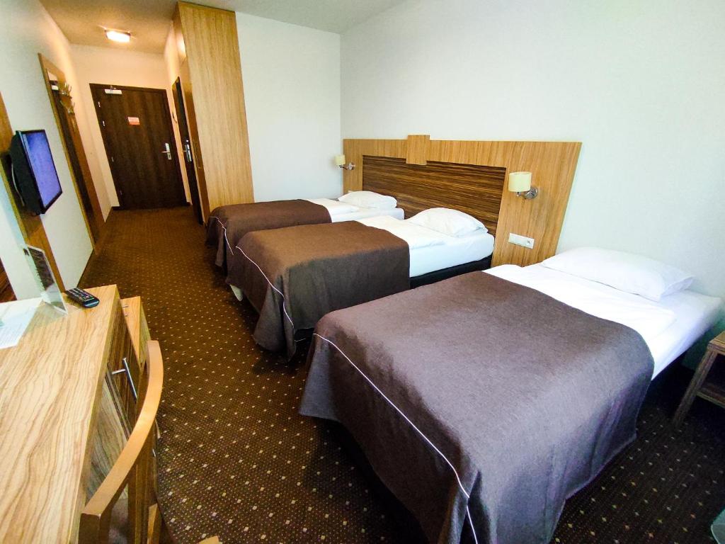 Postel nebo postele na pokoji v ubytování Hotel Milenium