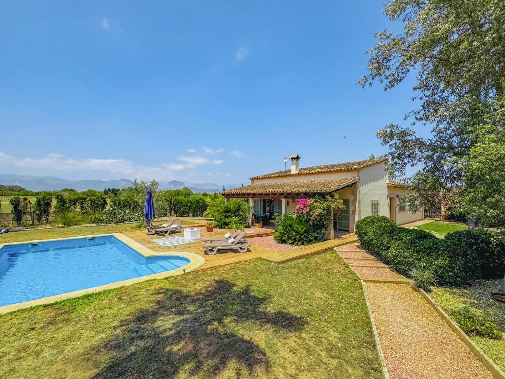 a house with a swimming pool in the yard at Stunning country villa with Panoramic mountain views in Biniali