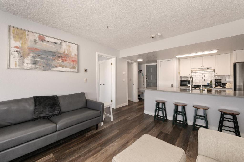 a living room with a couch and a kitchen at Summit Unit 1103 in Granby