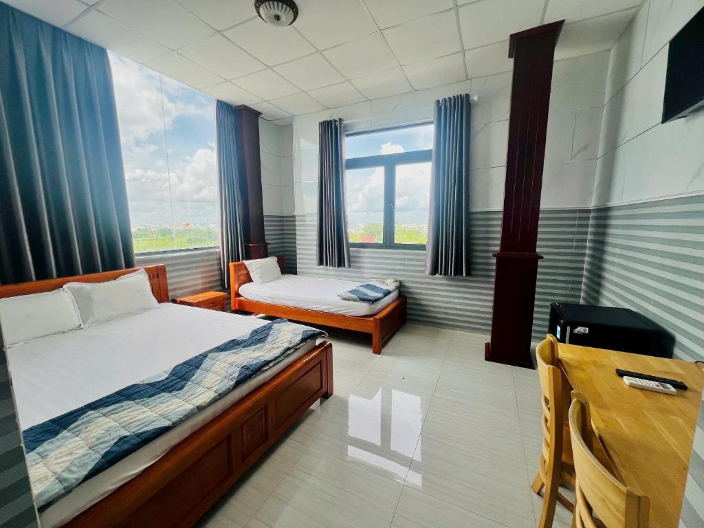 Postel nebo postele na pokoji v ubytování Hotel Sen Việt Bạc Liêu