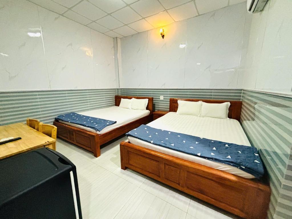 Postel nebo postele na pokoji v ubytování Hotel Sen Việt Bạc Liêu
