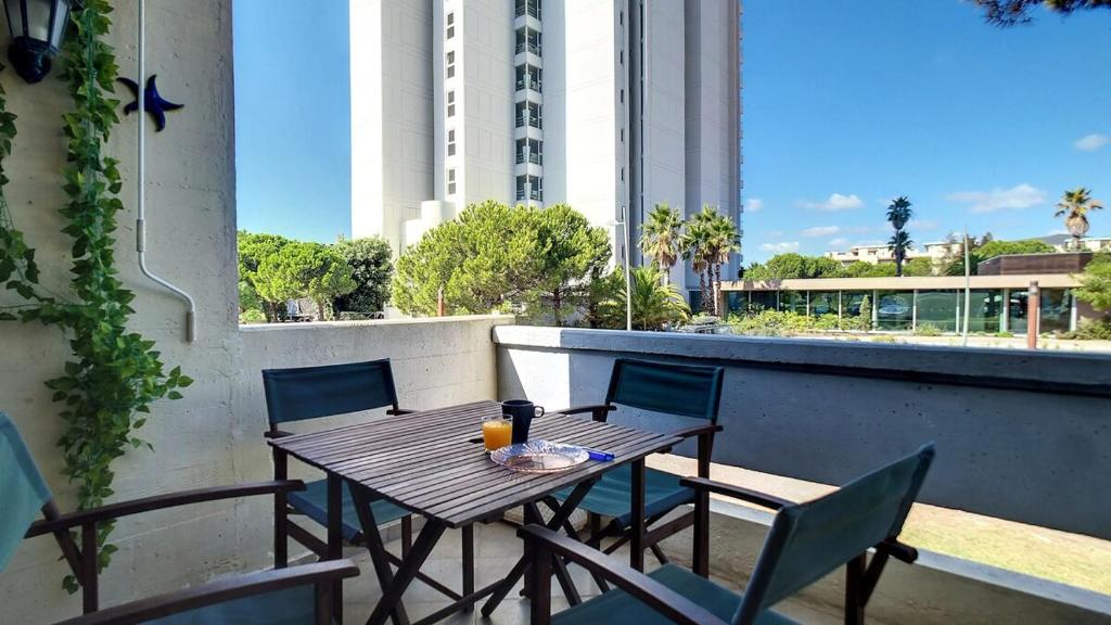 a table and chairs on the balcony of a building at Tróia 2 Minutes from the Beach in Troia