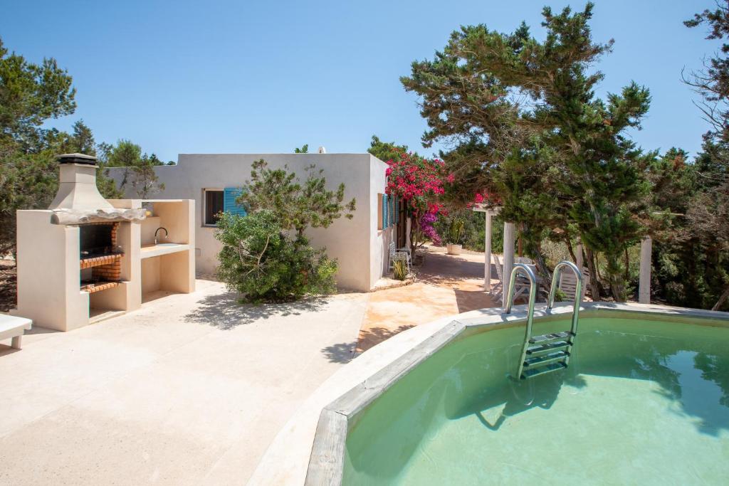 a swimming pool in front of a house at Casa Rustick in Sant Francesc Xavier