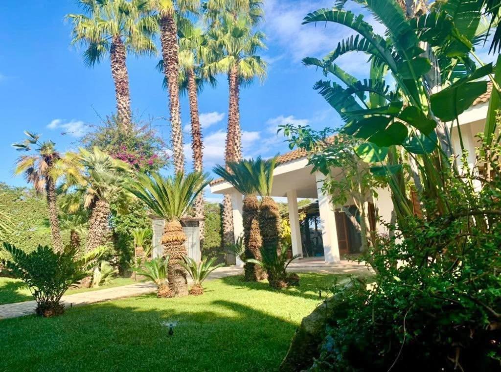 a house with palm trees in the yard at Villa Erika in Gallipoli