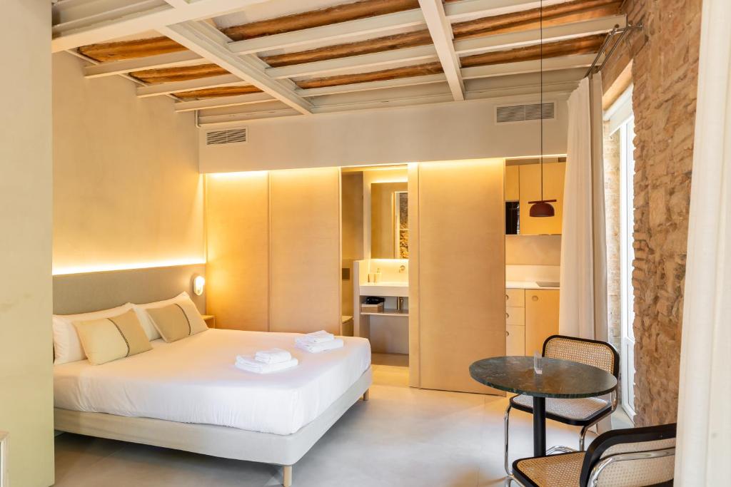a bedroom with a bed and a table in a room at Decô Apartments Barcelona-Born St. in Barcelona