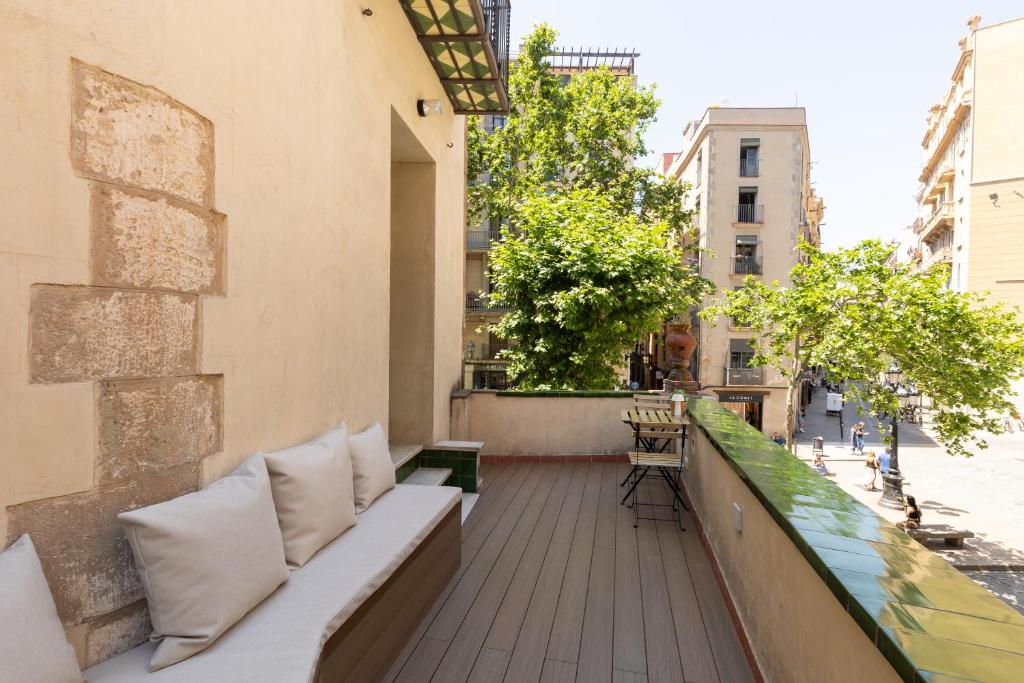 a balcony with white pillows on a building at Decô Apartments Barcelona-Born St. in Barcelona