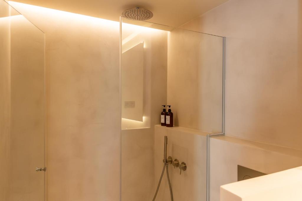a shower with a glass door in a bathroom at Decô Apartments Barcelona-Born St. in Barcelona