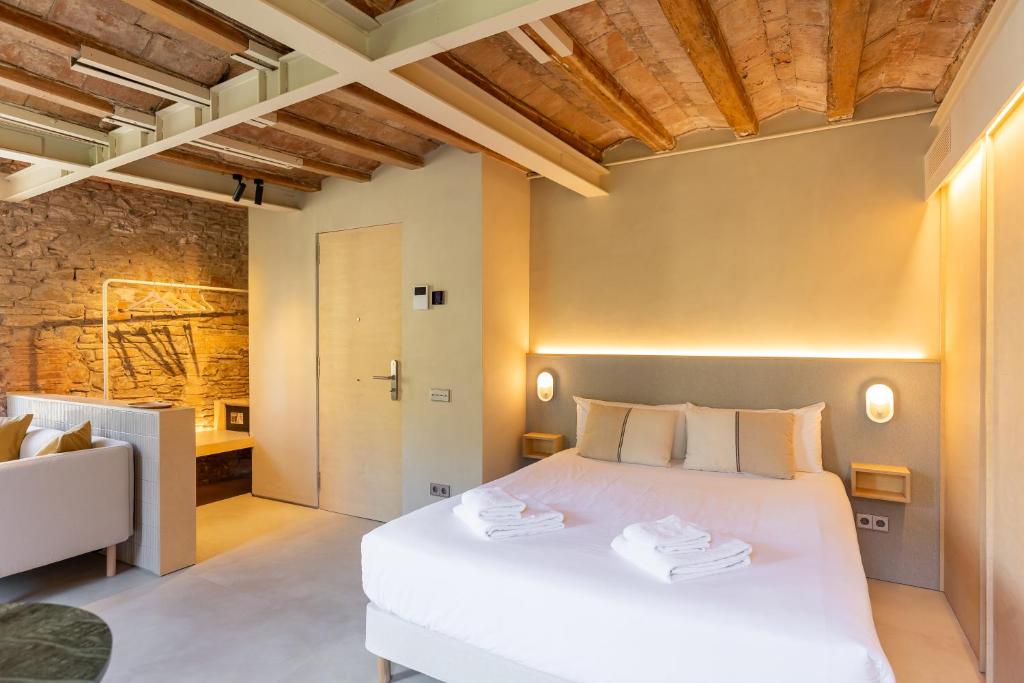 a bedroom with a large white bed in a room at Decô Apartments Barcelona-Born St. in Barcelona