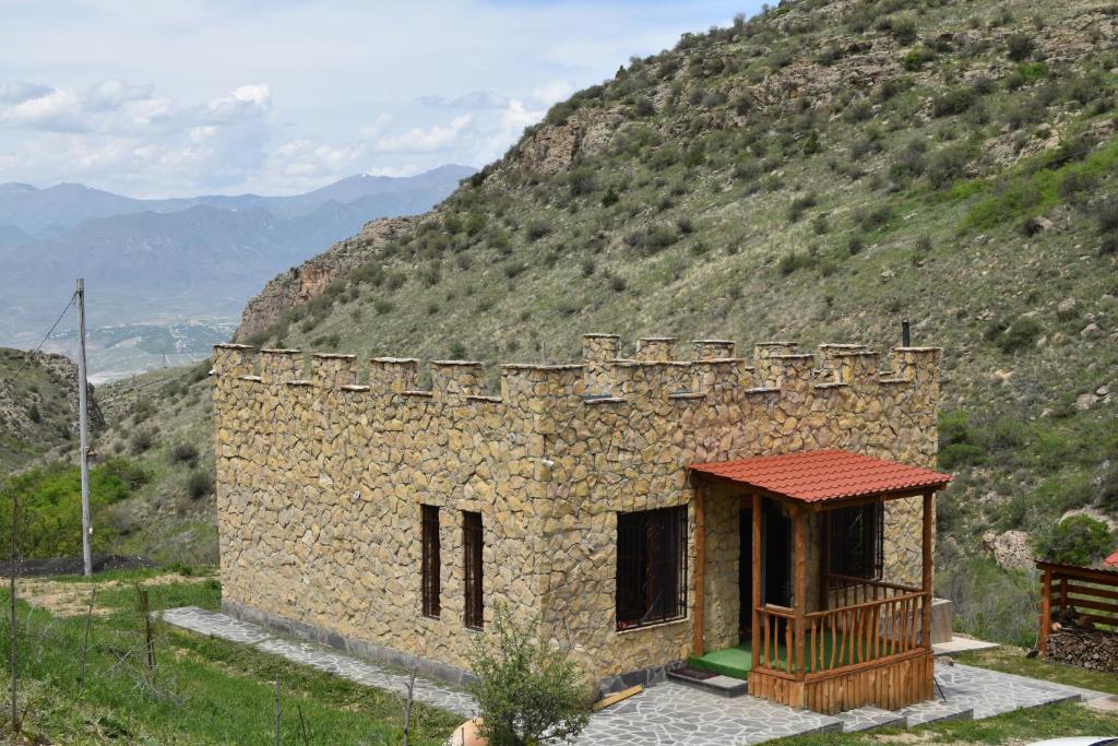 a small stone building on the side of a mountain at Cottage near Noravank, Areni, Sauna, Wine in Areni