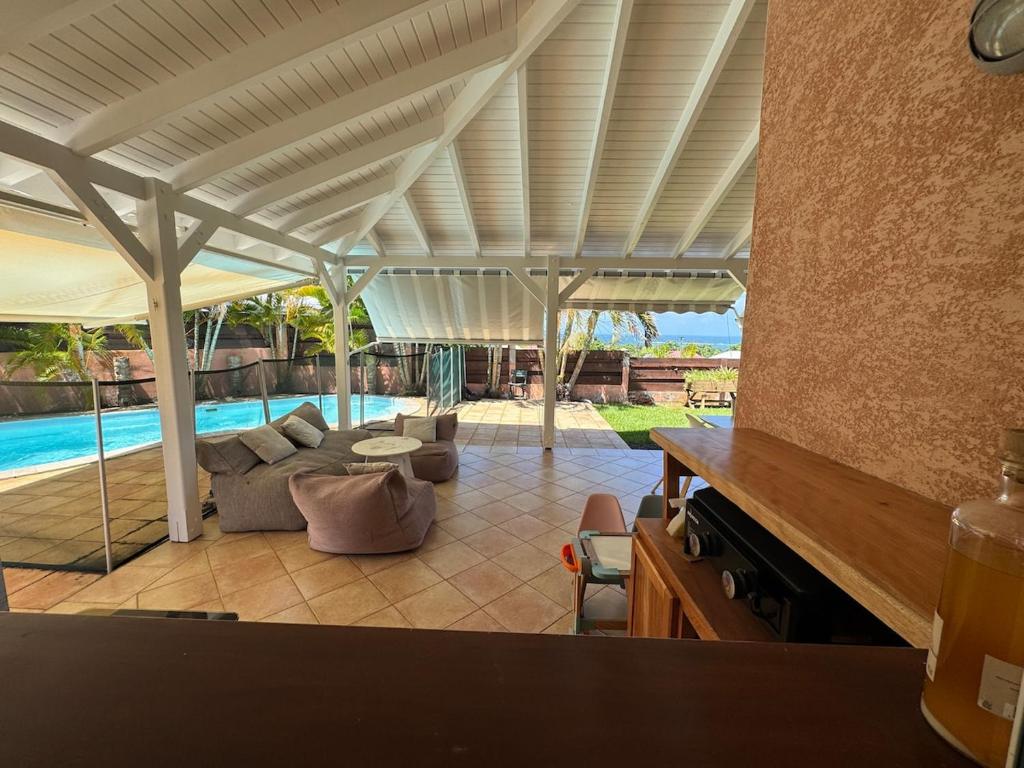 a living room with a couch and a table at Villa Morne-Bou in Petit-Bourg
