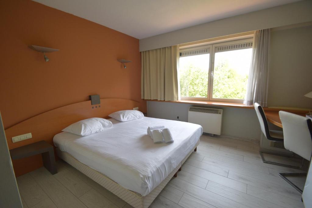 Postel nebo postele na pokoji v ubytování Sleep & Go Brussels Expo Hotel