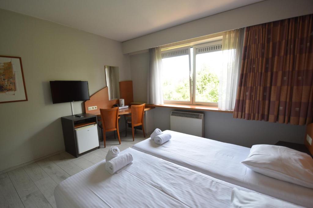 Postel nebo postele na pokoji v ubytování Sleep & Go Brussels Expo Hotel