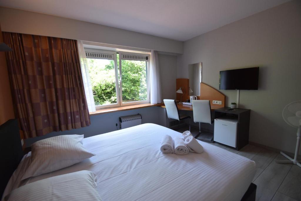 Postel nebo postele na pokoji v ubytování Sleep & Go Brussels Expo Hotel