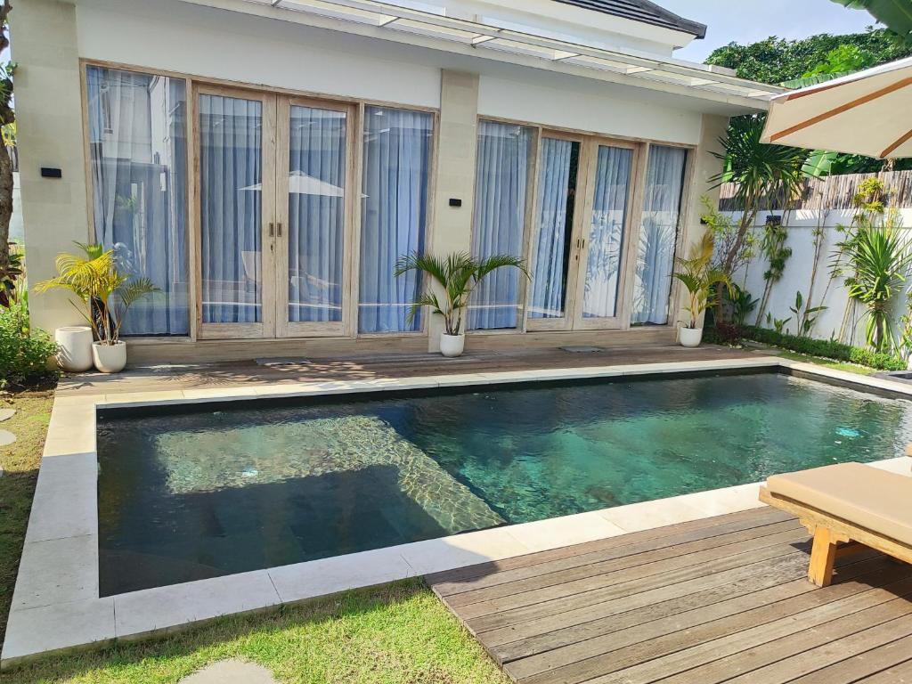 a swimming pool in the backyard of a house at Savana Villas Tanah Lot in Tanah Lot