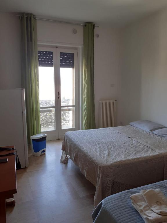 a bedroom with two beds and a window at Manzoni in Altamura