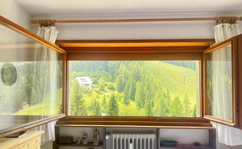 a window with a view of a mountain at Mono Fiorrancino in Folgaria
