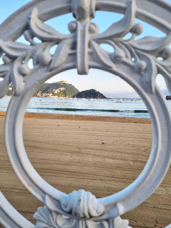 a view of the beach through a metal fence at Hotel Zaragoza Plaza in Donostia-San Sebastián