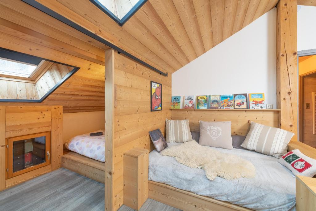 a bedroom in a log cabin with a bed at Le chalet de Nicolas - Your Nature Exclusive Retreat ! in Le Tholy