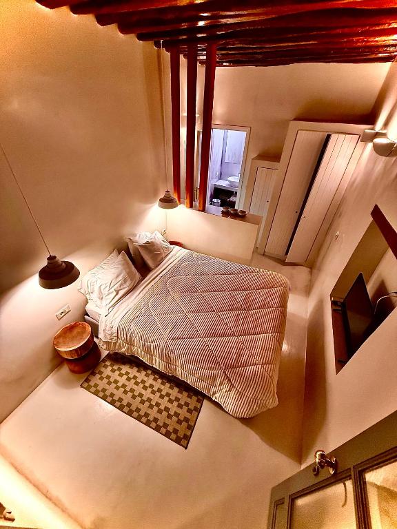 a small bedroom with a bed and a window at Amerissas studios 3 in Skiros