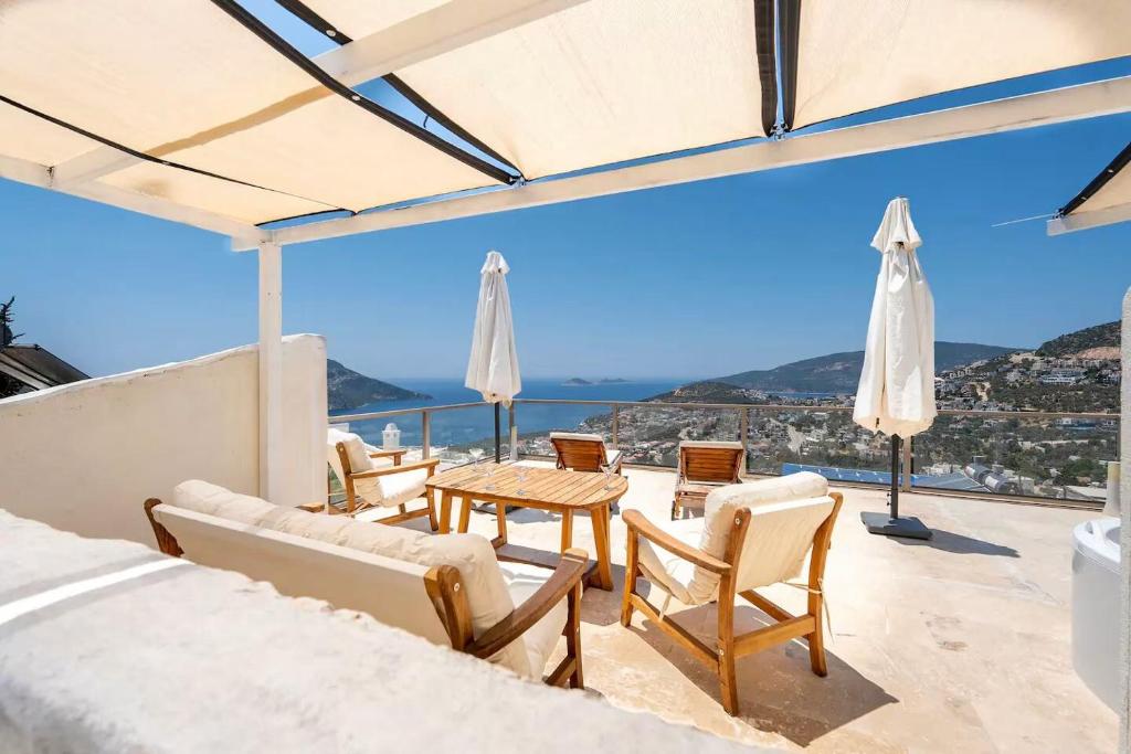 un patio con sedie e tavoli e vista sull'oceano di Luxury Two Bedroom Seaview Villa in Kalkan a Kaş