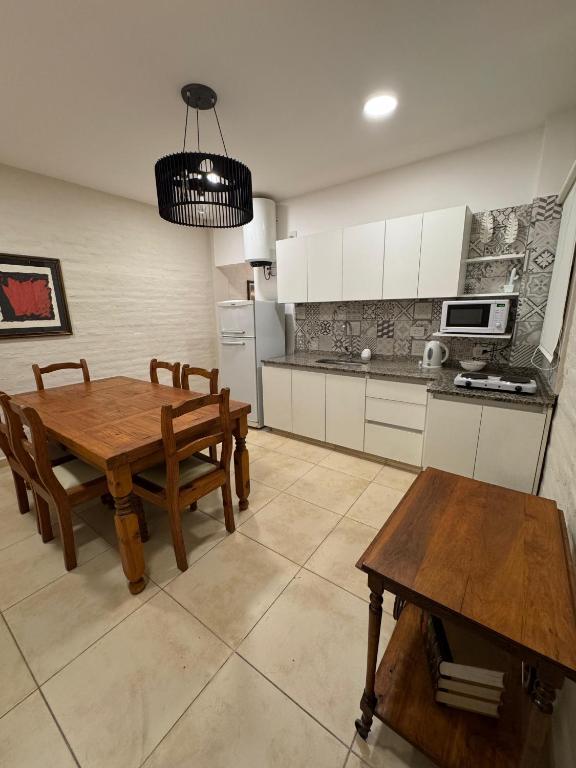 a kitchen with a wooden table and a dining room at Don Antonio Apart 4 in Resistencia