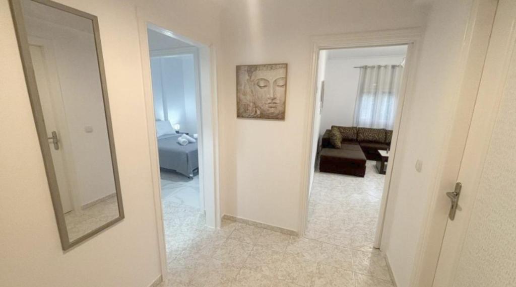 a hallway with a mirror and a living room at Lemon Suites 2 in Mytilini