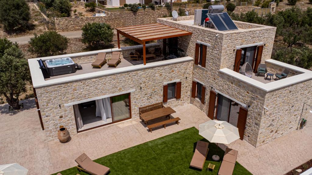 an aerial view of a house with a patio at Sun and Sea Cretan Hospitality in Pitsidia