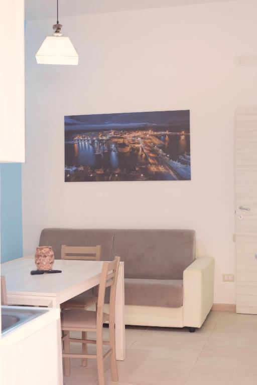a living room with a couch and a table at AP Apartment - in centro! in Gallipoli
