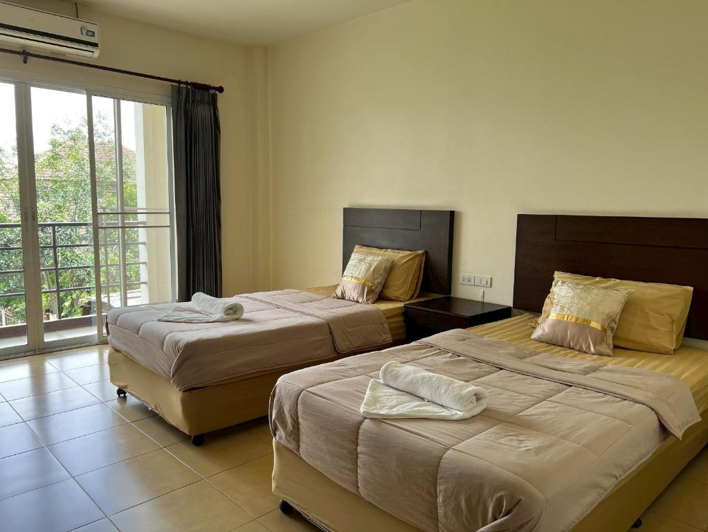 Postel nebo postele na pokoji v ubytování JB Mansion Hotel