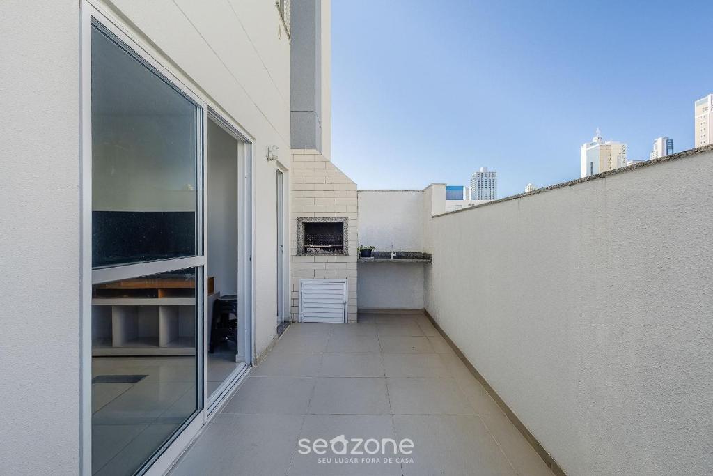 a balcony of a building with a large window at Apt c/ Churrasq. a 600m da Praia GEN0102 in Balneário Camboriú