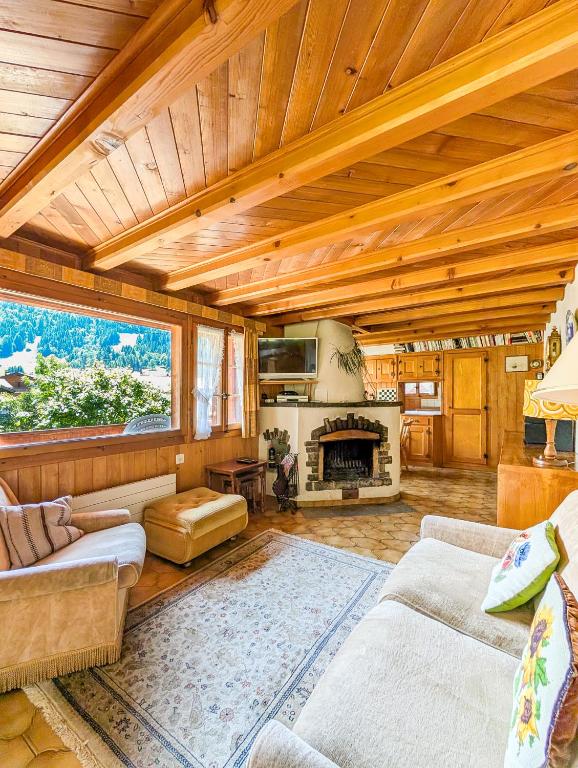 a living room with a couch and a fireplace at Havre de paix aux Diablerets - chalet privé in Les Diablerets
