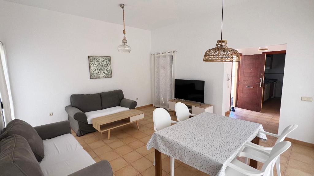 a living room with a couch and a table at Anahi Homes Corralejo- Bicacarera 7 in La Oliva