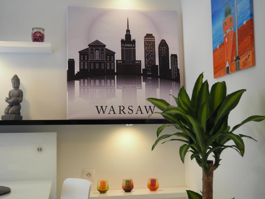 a wall with a poster of a city at Apartament Kapelanów in Warsaw