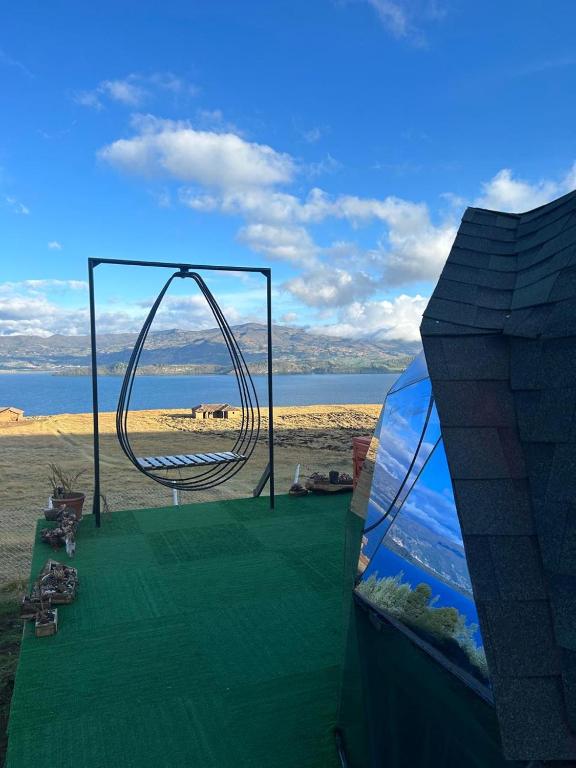 a playground with a swing on the beach at San Jerónimo Glamping in Tota