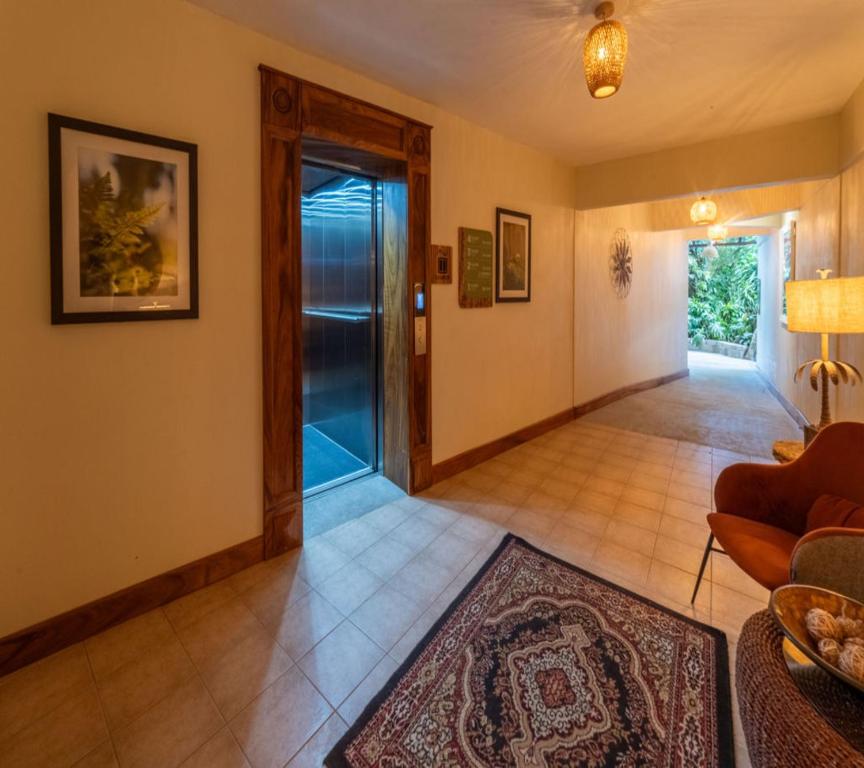 a living room with a door and a rug at Hotel & Spa Poco a Poco - Costa Rica in Monteverde Costa Rica