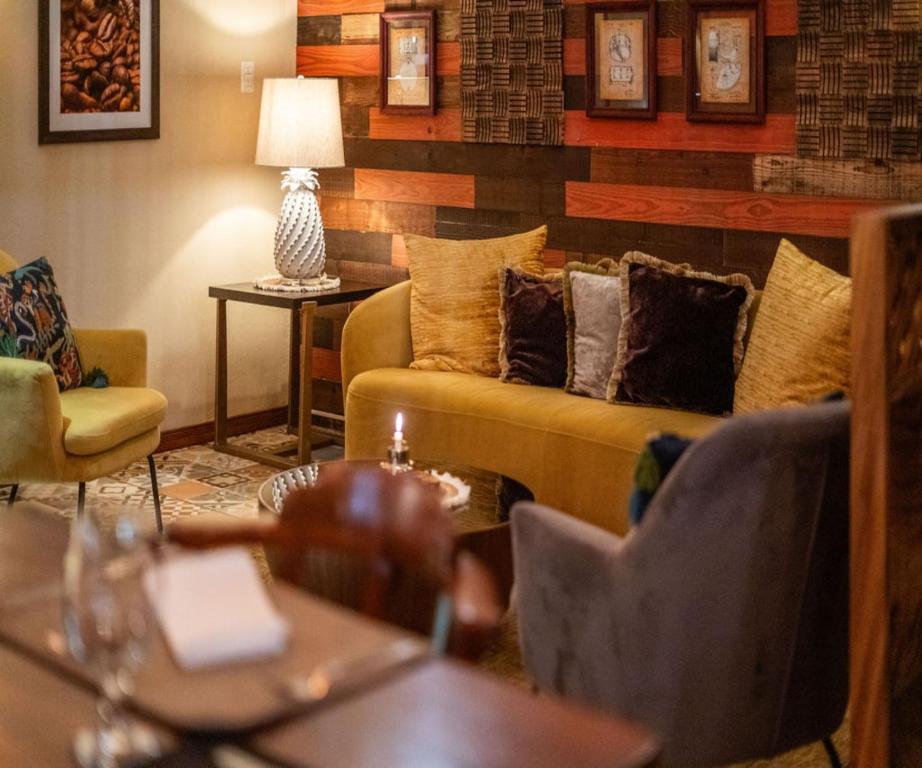 a living room with a couch and chairs at Hotel & Spa Poco a Poco - Costa Rica in Monteverde Costa Rica