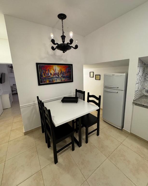 a dining room with a white table and chairs at Don Antonio Apart 3 in Resistencia