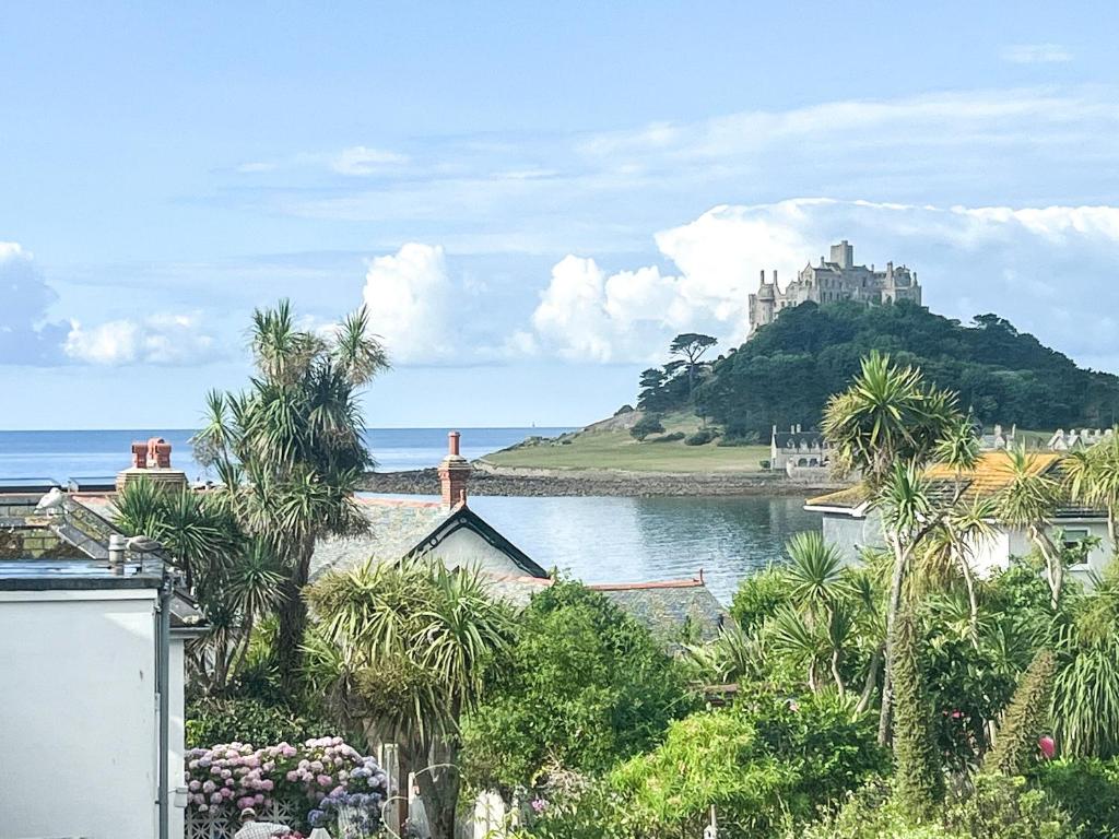 a castle on a hill with a body of water at Seaglass in Marazion