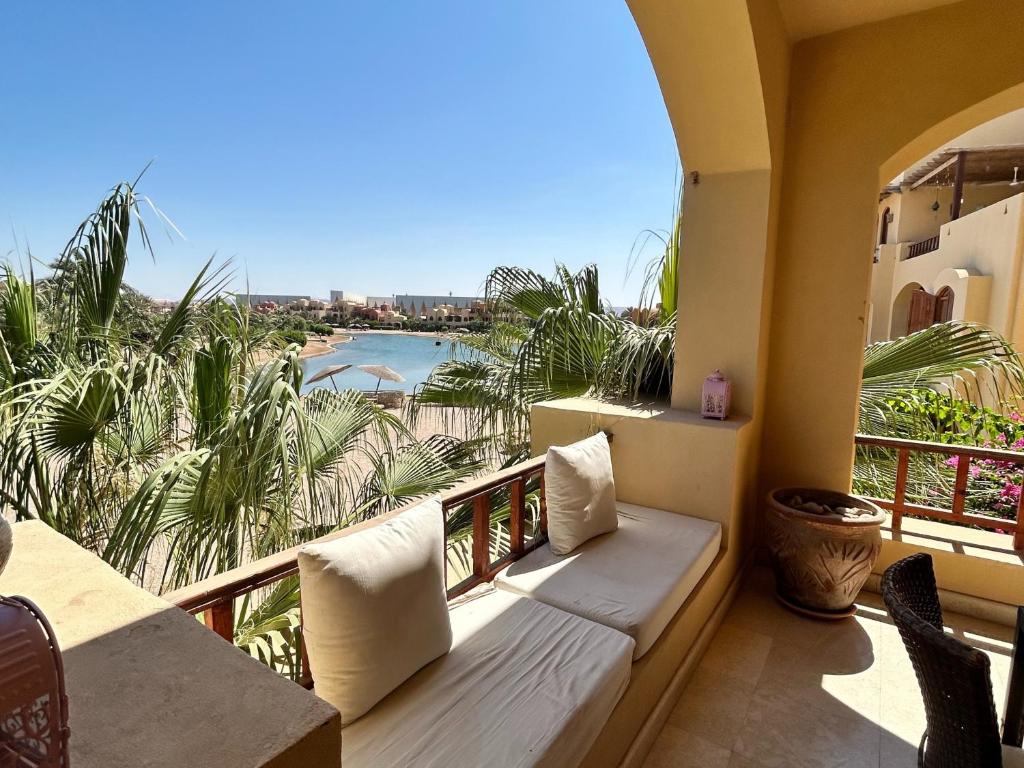 a balcony with a couch and a view of the ocean at Hurghada Concierge in EL-Gouna in Hurghada