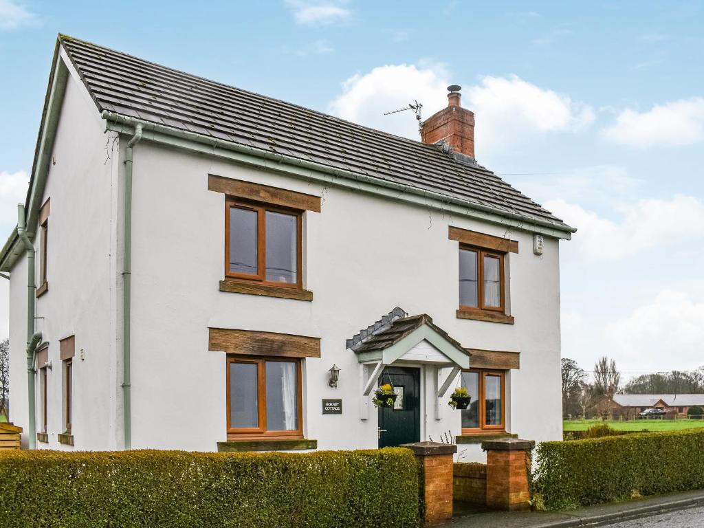 a white house with a black roof at Hornby Cottage in Saint Michaels on Wyre