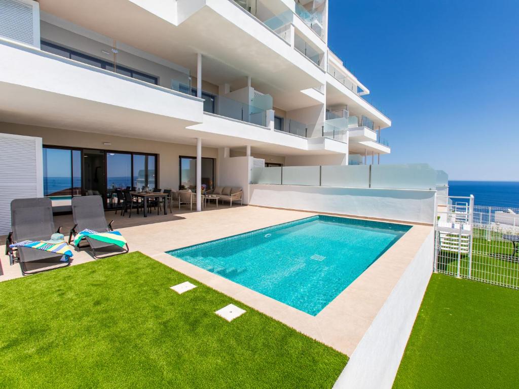 a swimming pool in the backyard of a house at Apartment Collection View Free Spa & Padel by Interhome in Torrox Costa