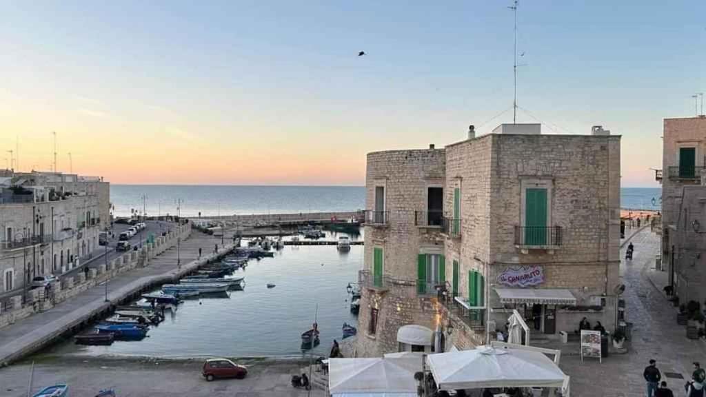 a group of boats in a river in a city at Studio in Giovinazzo - Apulien 54437 in Giovinazzo
