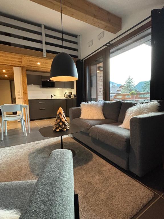 ein Wohnzimmer mit Sofa und Tisch in der Unterkunft Les Lucioles in Saint-Jean-de-Sixt