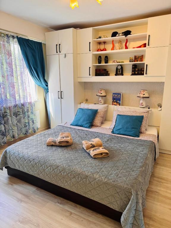 a bedroom with a large bed with two towels on it at Elisea apartment in Ruse