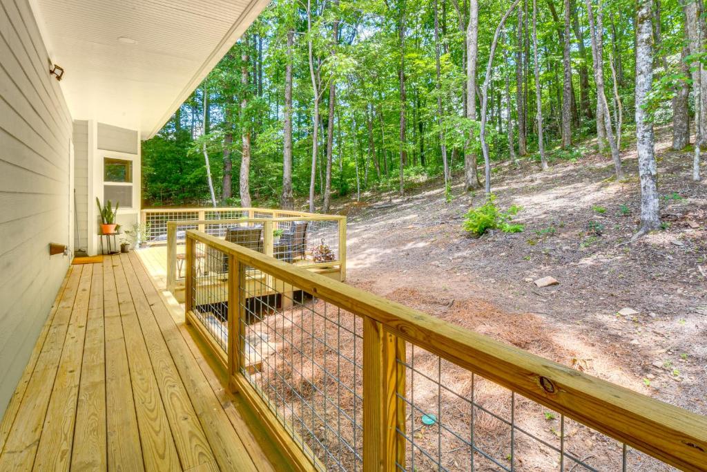 a porch of a home with a fence and trees at Pool and Golf Access Family Cabin in Clayton in Clayton