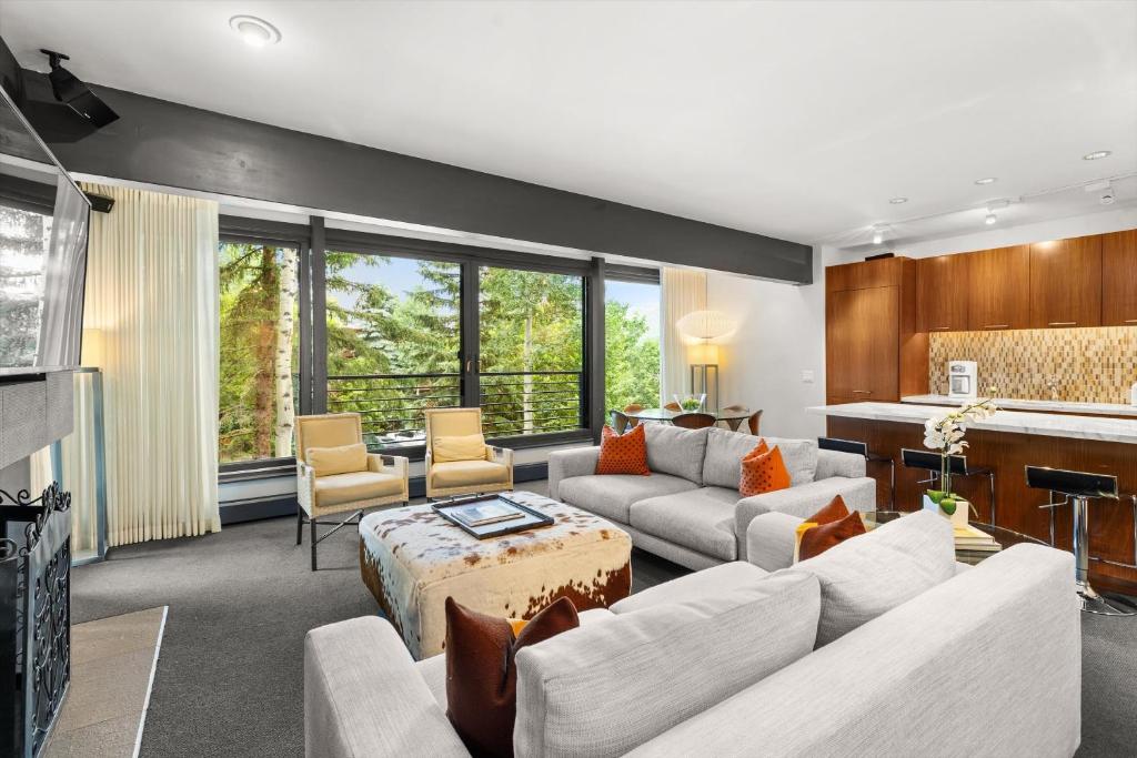 a living room with a couch and a table at Durant Unit C2, Condo with Designer Finishes, Great Views & Location in Aspen