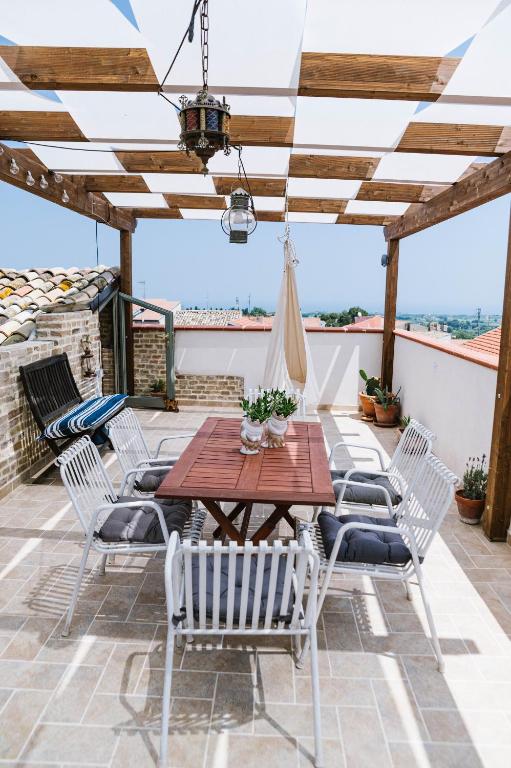 a patio with a wooden table and chairs at Villa Adriatica - Character Home, Costa dei Trabocchi in Villalfonsina